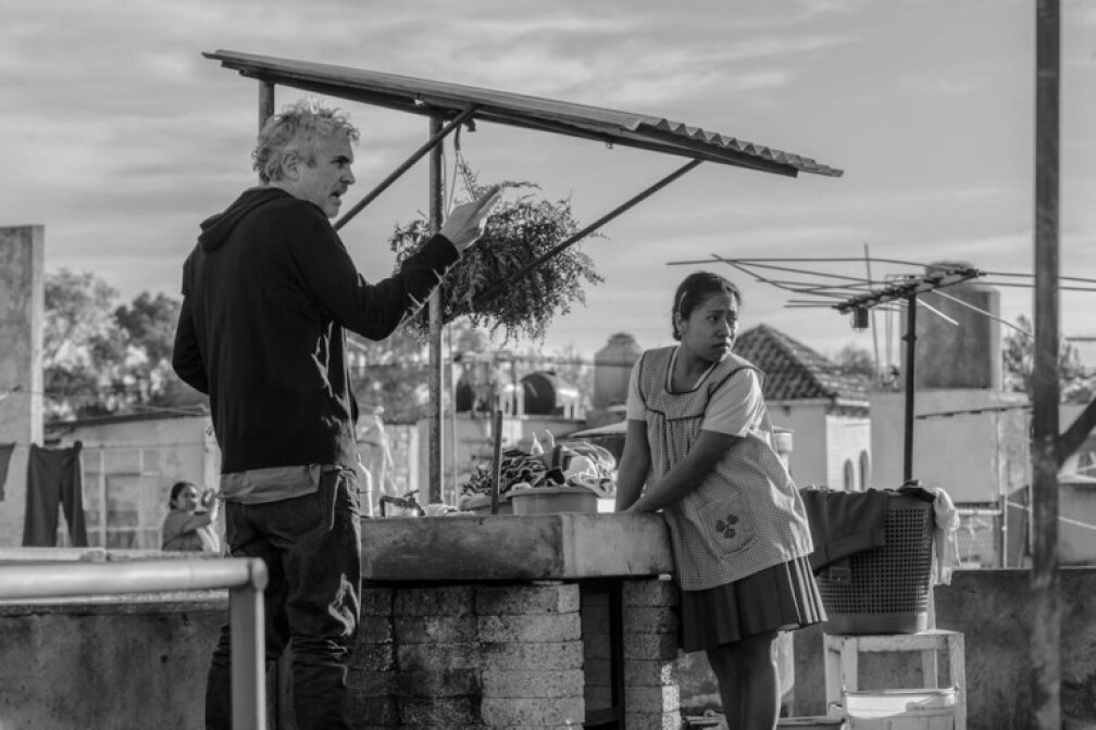 Director Alfonso Cuarón on the set of "Roma" with Yalitza Aparicio, the school teacher he chose to play a key role in his childhood memoir. 